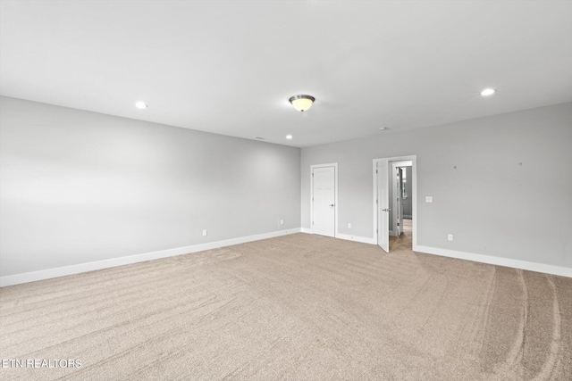 unfurnished room featuring light carpet