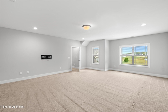 unfurnished room featuring light carpet