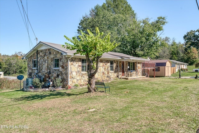 exterior space featuring a storage shed, a yard, and cooling unit