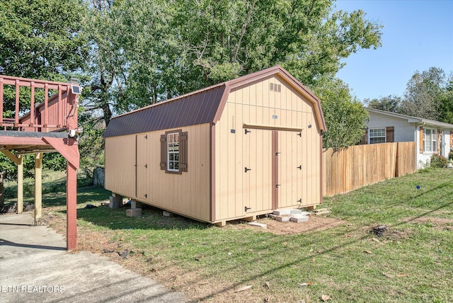 view of outbuilding with a lawn