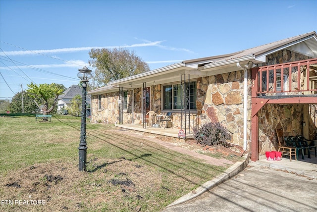 back of house with a patio and a yard