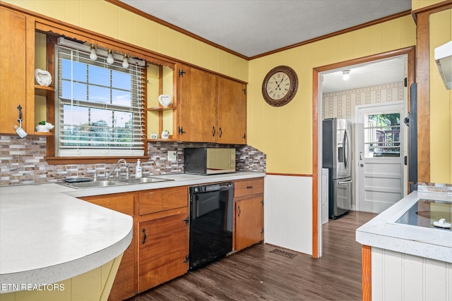 kitchen with dishwasher, dark hardwood / wood-style flooring, plenty of natural light, stainless steel fridge, and decorative backsplash