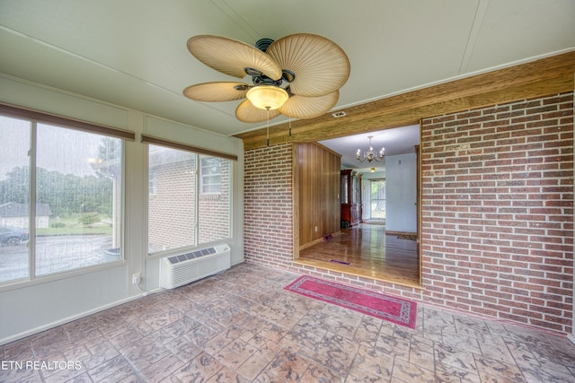 unfurnished sunroom featuring a wall mounted AC and ceiling fan with notable chandelier