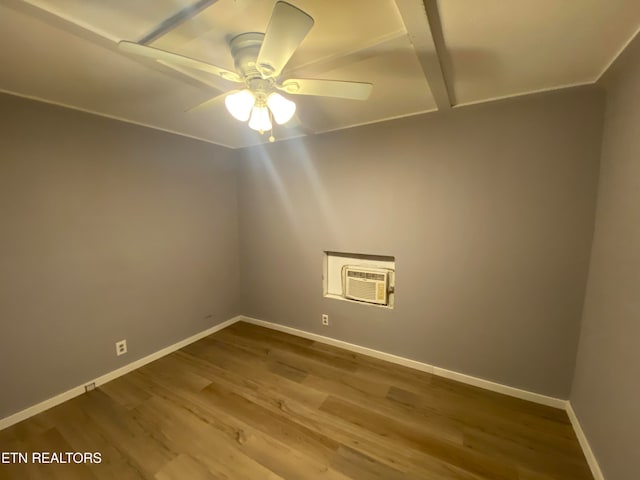 spare room with ceiling fan, a wall mounted air conditioner, and wood-type flooring