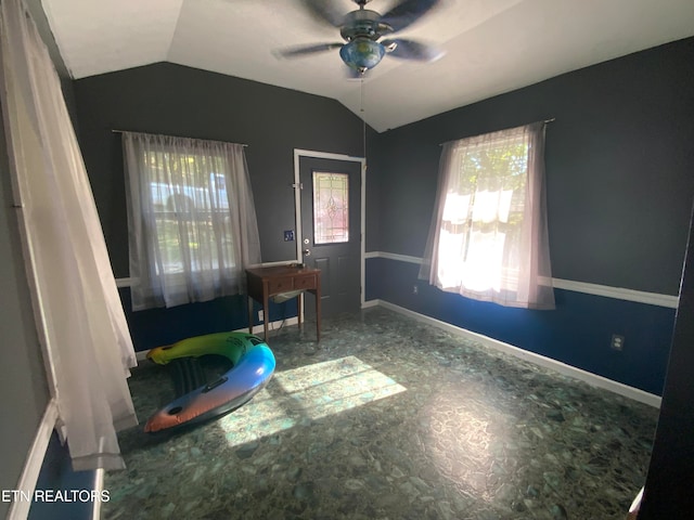 interior space with ceiling fan, lofted ceiling, and a healthy amount of sunlight