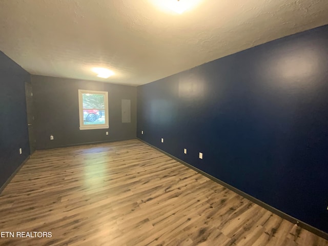 spare room featuring wood-type flooring