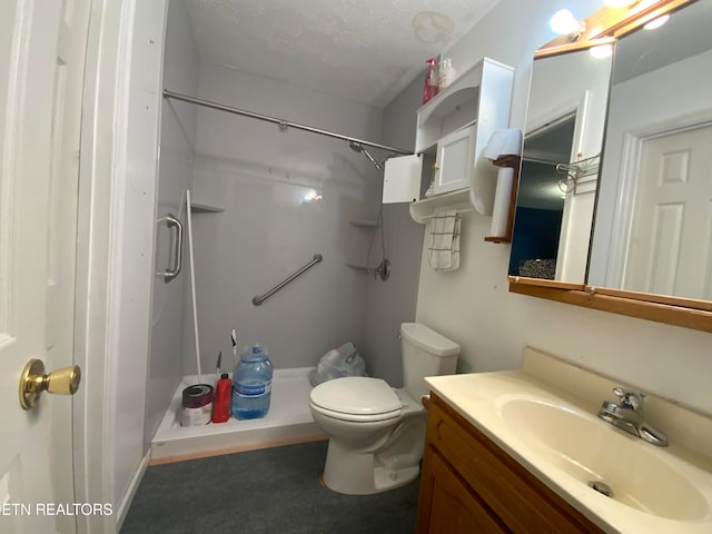 bathroom with toilet, vanity, a shower, and a textured ceiling