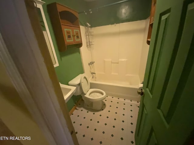 bathroom featuring bathtub / shower combination and toilet