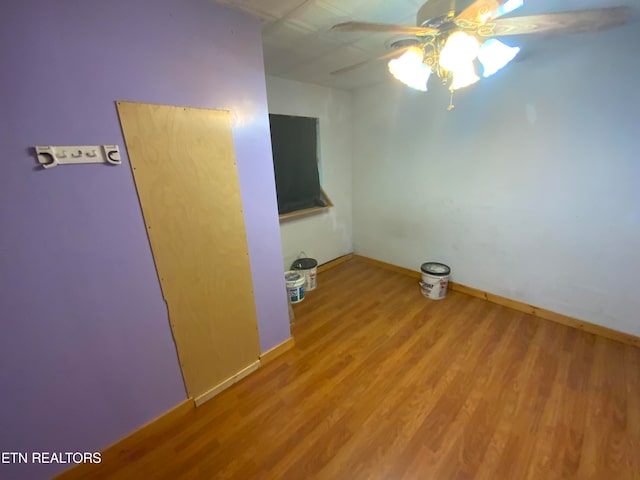 empty room with hardwood / wood-style flooring and ceiling fan