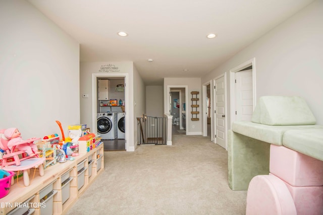 game room with separate washer and dryer and light colored carpet