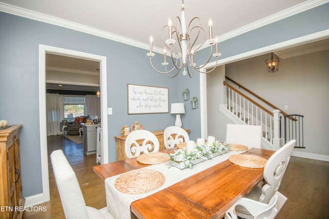 dining area featuring dark hardwood / wood-style floors, crown molding, and a notable chandelier