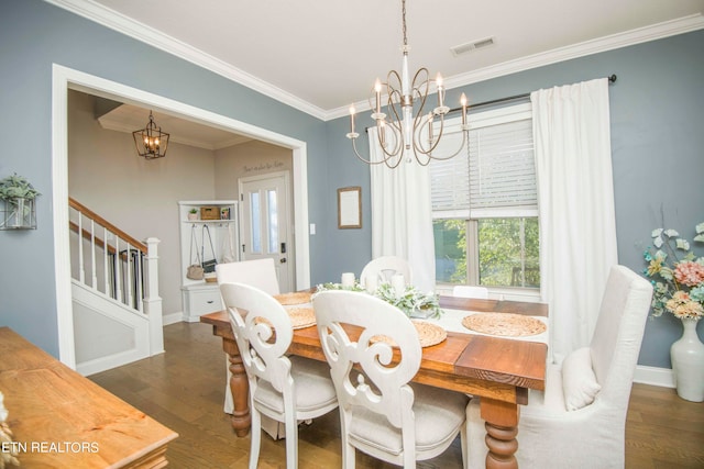 dining space with ornamental molding, a notable chandelier, and dark wood-type flooring