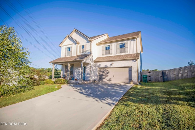 view of front of home featuring a garage and a front lawn