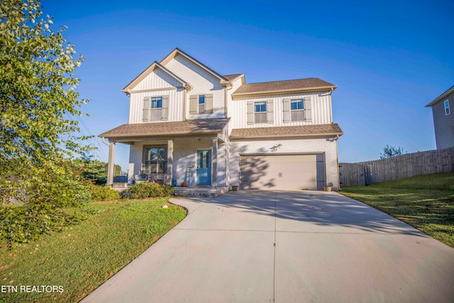 view of front of home with a garage, a porch, and a front yard