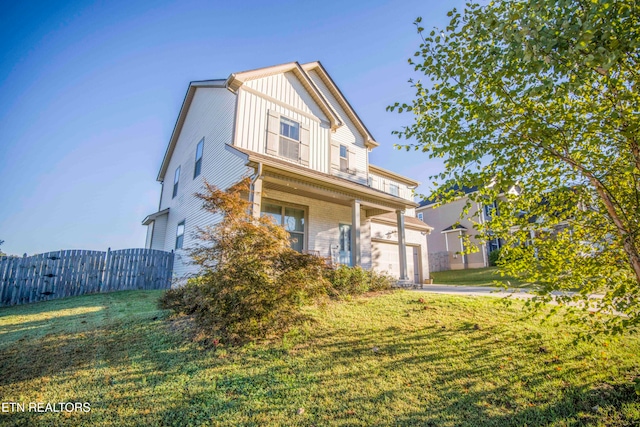 view of front of home featuring a front lawn and a garage