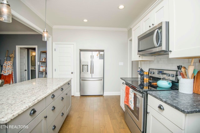 kitchen with white cabinets, light hardwood / wood-style flooring, stainless steel appliances, a center island, and crown molding