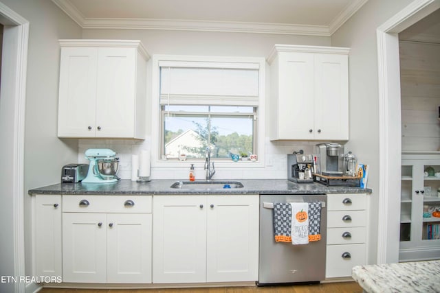 kitchen featuring stainless steel dishwasher, tasteful backsplash, white cabinets, dark stone countertops, and crown molding