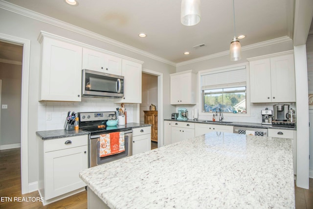 kitchen with wood-type flooring, white cabinetry, sink, and stainless steel appliances