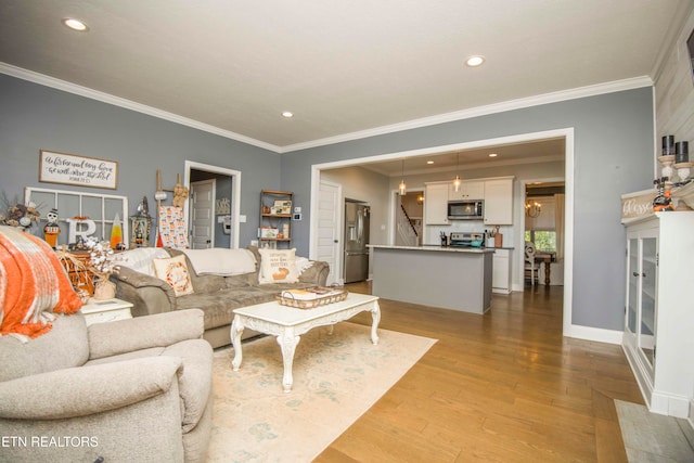 living room featuring crown molding and light hardwood / wood-style flooring