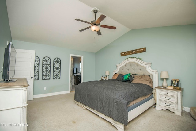 bedroom with light carpet, vaulted ceiling, ensuite bathroom, and ceiling fan