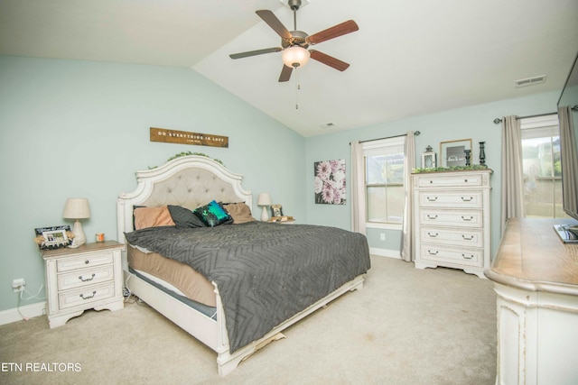 bedroom with ceiling fan, light carpet, and vaulted ceiling