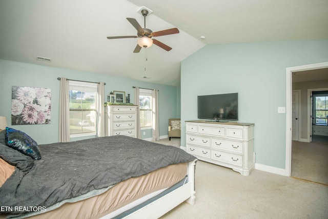 bedroom with lofted ceiling, multiple windows, ceiling fan, and light carpet