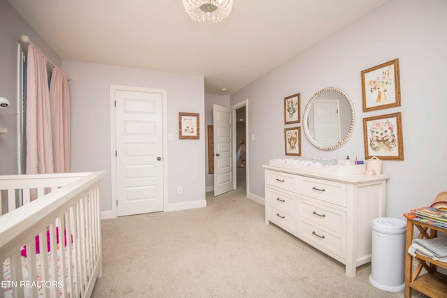 carpeted bedroom featuring a crib