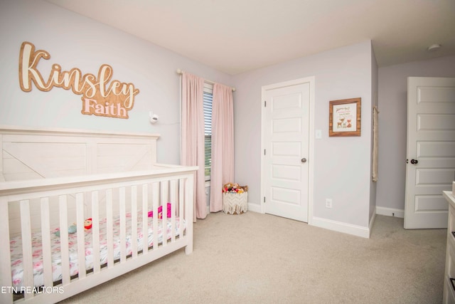 carpeted bedroom with a crib