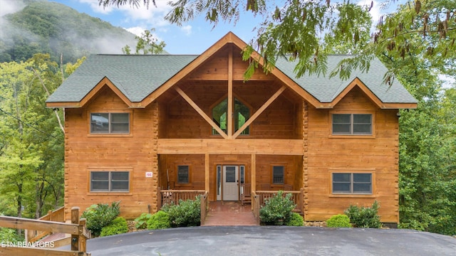 log cabin featuring covered porch