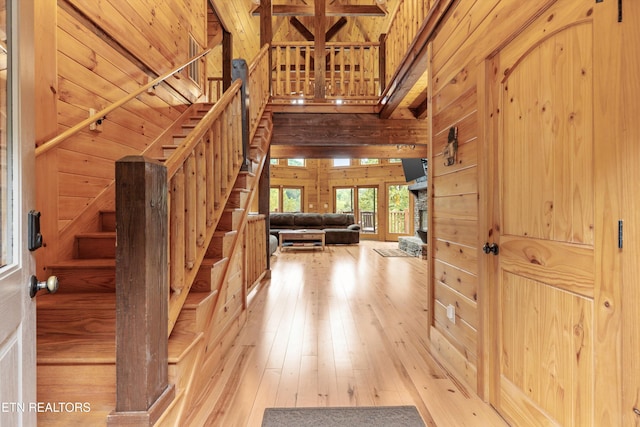 entrance foyer featuring wooden walls and light hardwood / wood-style floors