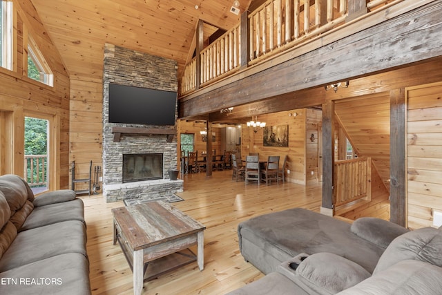 living room featuring wood walls, wooden ceiling, high vaulted ceiling, and light hardwood / wood-style flooring