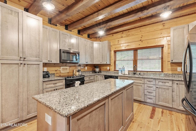 kitchen featuring beamed ceiling, light hardwood / wood-style flooring, sink, and black appliances