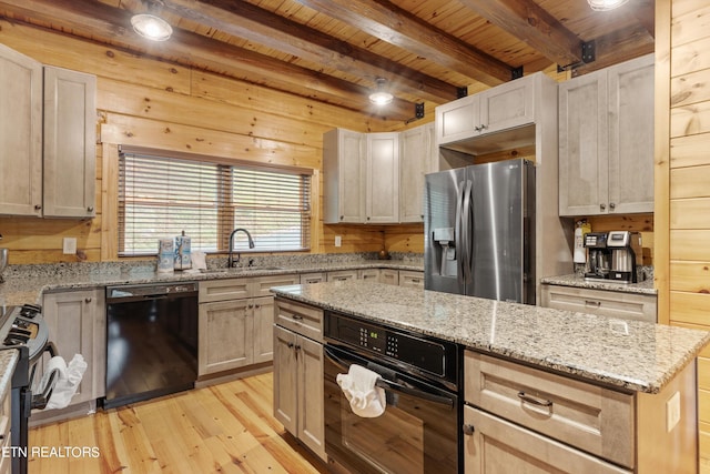 kitchen with beamed ceiling, black appliances, light stone countertops, wooden ceiling, and light hardwood / wood-style floors