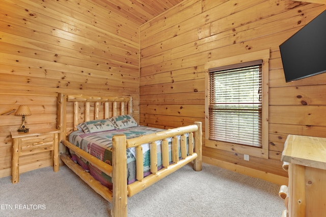 bedroom featuring light carpet, wood walls, and wood ceiling