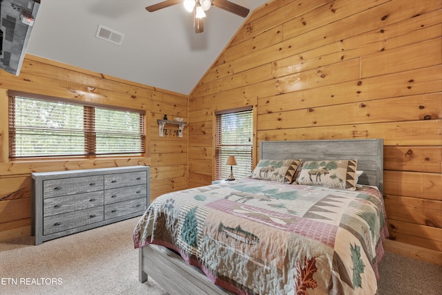 bedroom featuring wooden walls, ceiling fan, and vaulted ceiling