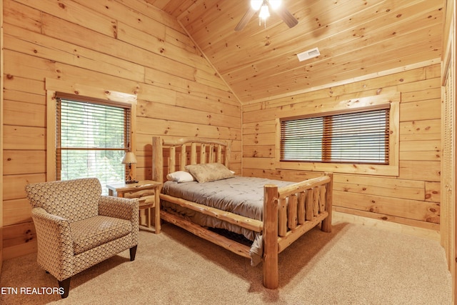 carpeted bedroom with ceiling fan, wooden walls, vaulted ceiling, and wood ceiling