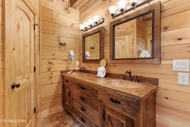 bathroom with vanity and wood walls