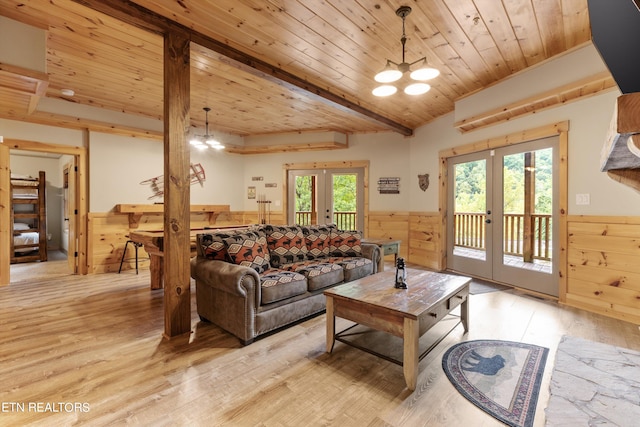 living room with french doors, wooden ceiling, a notable chandelier, light hardwood / wood-style flooring, and wood walls