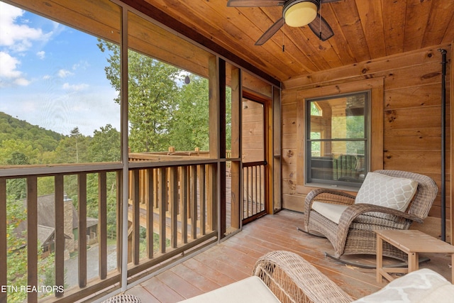 sunroom / solarium with plenty of natural light and ceiling fan