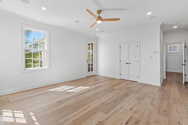 unfurnished bedroom featuring ceiling fan, ornamental molding, and light wood-type flooring