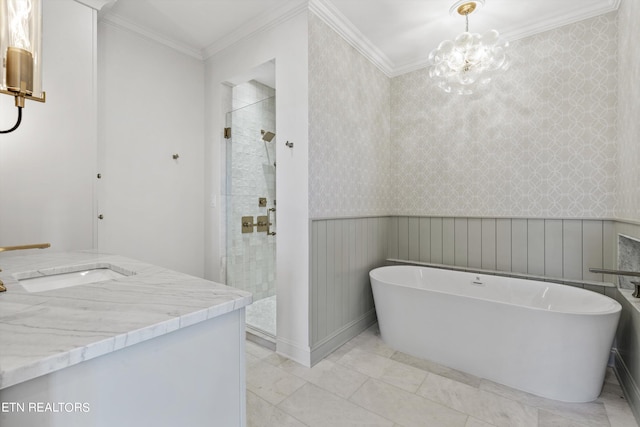 bathroom featuring plus walk in shower, vanity, a chandelier, and crown molding