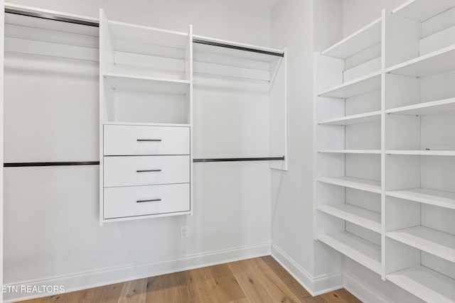 walk in closet featuring light hardwood / wood-style flooring