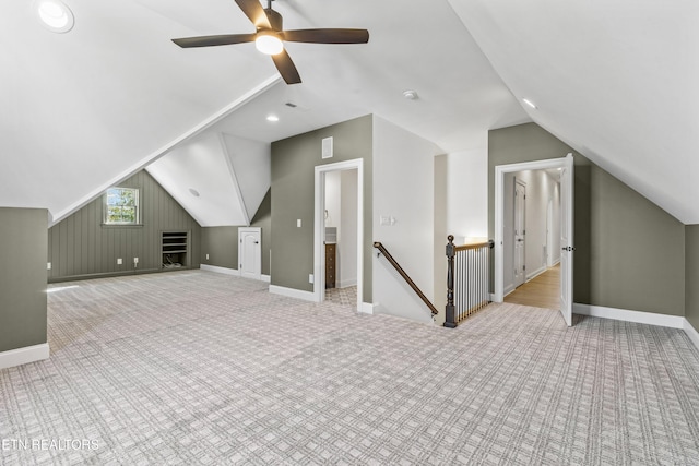 additional living space featuring ceiling fan, light colored carpet, and lofted ceiling