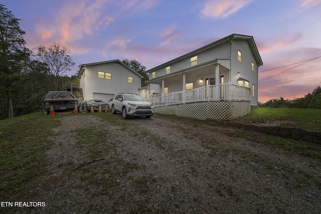 view of front facade with a porch and a garage