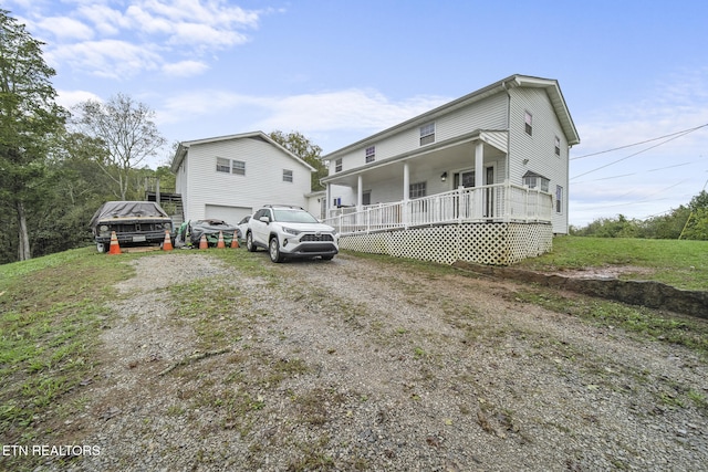 view of front facade featuring a porch and a garage