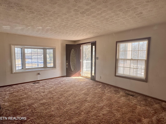 9832 Clift Rd, Strawberry Plains, TN 37871 - carpeted entryway featuring visible vents, baseboards, and a healthy amount of sunlight