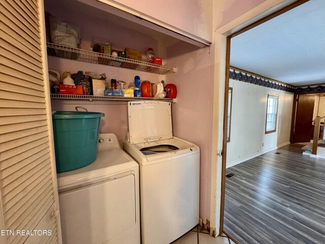 9832 Clift Rd, Strawberry Plains, TN 37871 - laundry room featuring independent washer and dryer, laundry area, wood finished floors, and baseboards