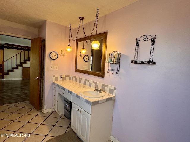 9832 Clift Rd, Strawberry Plains, TN 37871 - bathroom with tile patterned floors, vanity, baseboards, and decorative backsplash
