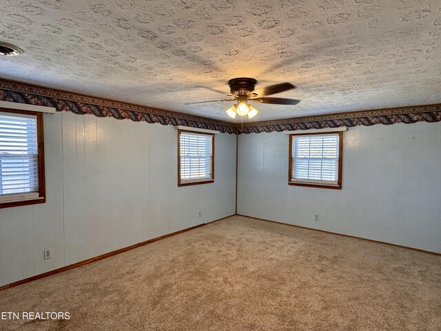 9832 Clift Rd, Strawberry Plains, TN 37871 - unfurnished room with visible vents, ceiling fan, light carpet, and a textured ceiling