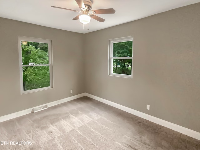 carpeted empty room featuring ceiling fan